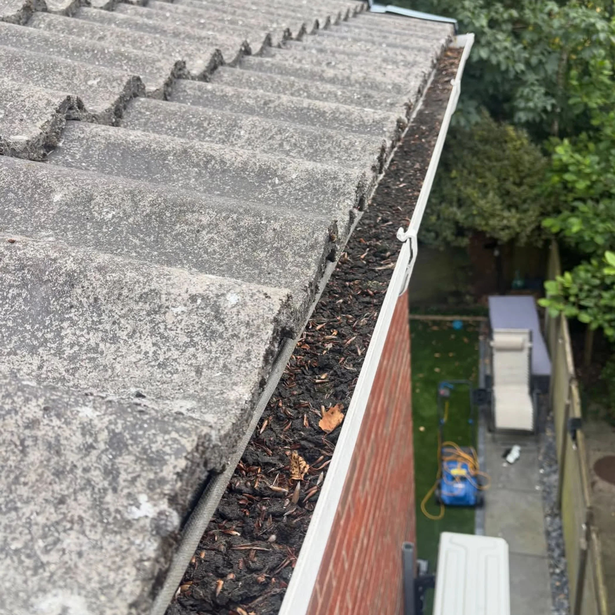 gutter filled with leaves needing cleaning